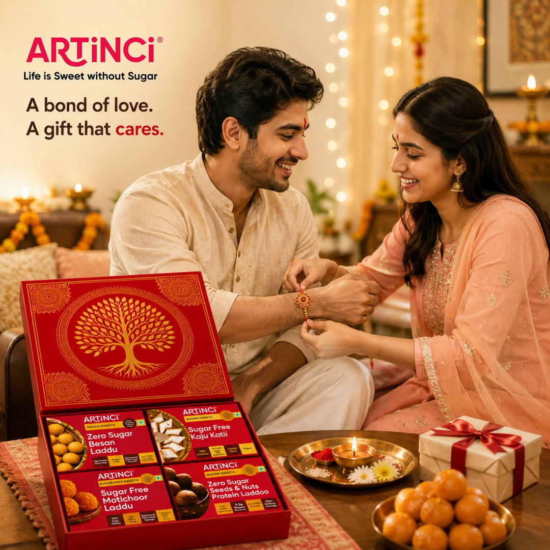 A man and woman sitting together in a warmly lit festive home setting, receiving a traditional wrist ornament from each other. In the foreground, an open red ARTiNCI gift box filled with packaged snacks is displayed beside a plate of orange sweets and a wrapped gift box.