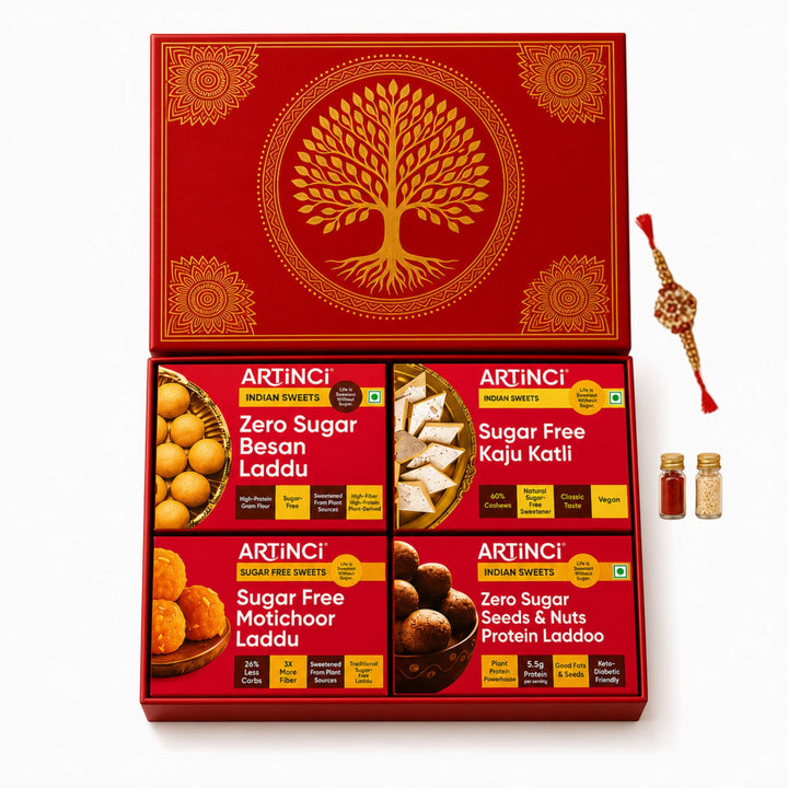 An open red ARTINCI gift box containing four varieties of sugar-free Indian sweets, shown on a clean white background with a decorative red and gold Rakhi thread bundle and two small spice jars to the right.