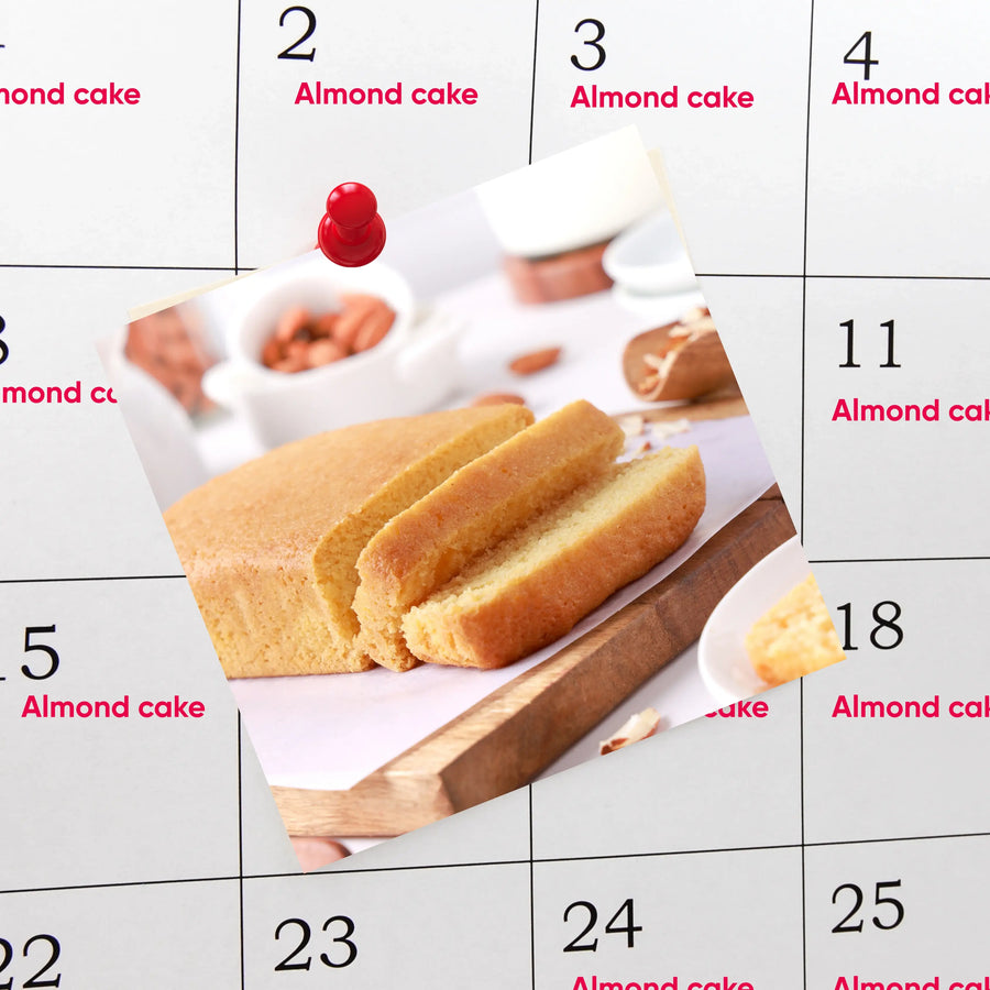 Calendar with images of almond cake and ingredients on a white background